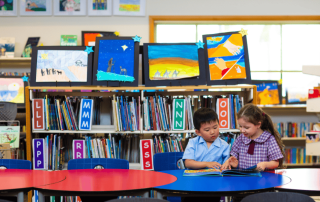 Two students from Sacred Heart Catholic Primary School Villawood reading and learning in the school library